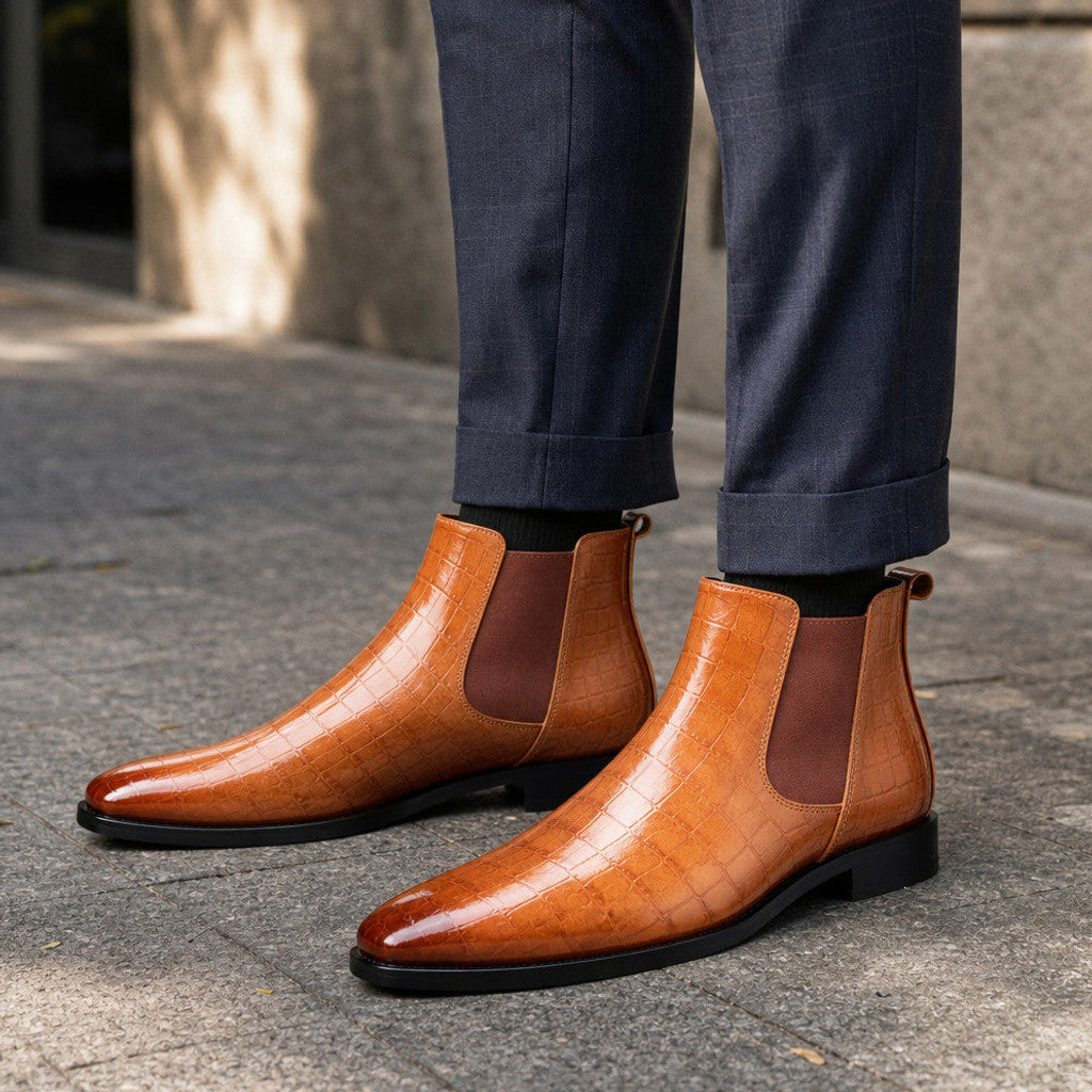 Man wearing cognac brown croc-embossed chelsea boots with dark denim