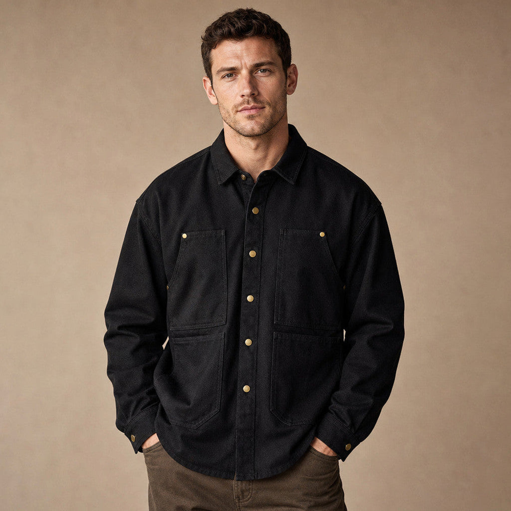 Man wearing black canvas snap front utility shirt open over a tee