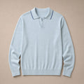 Man wearing powder blue knit polo with grey trousers