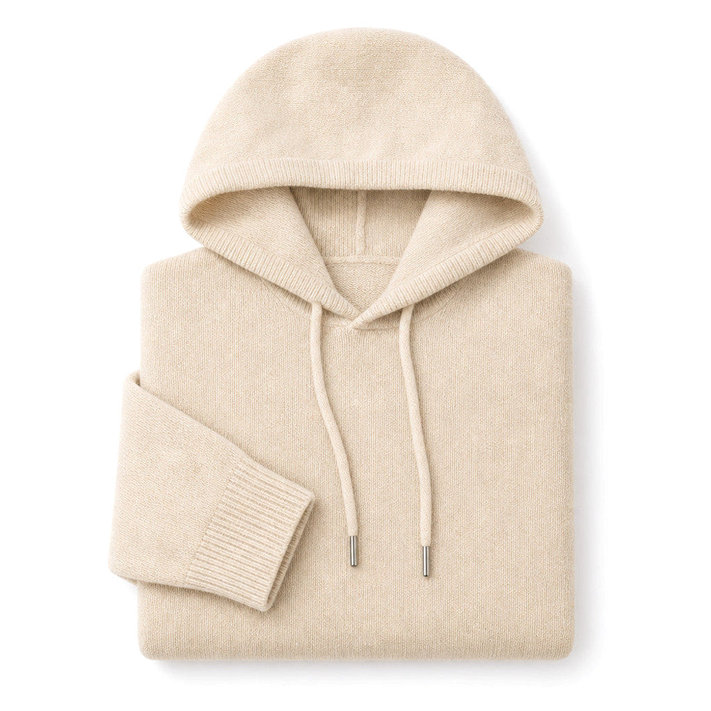 Man wearing beige wool knit hoodie over a shirt with dark trousers
