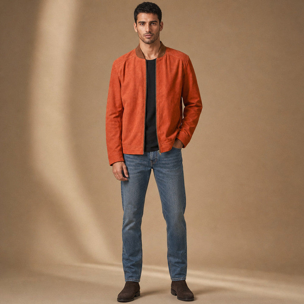 Man wearing an orange suede bomber jacket with dark denim