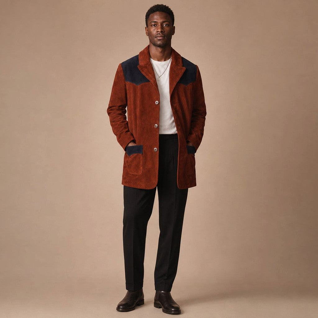 Man wearing a rust brown suede patch blazer over a fine knit with dark denim