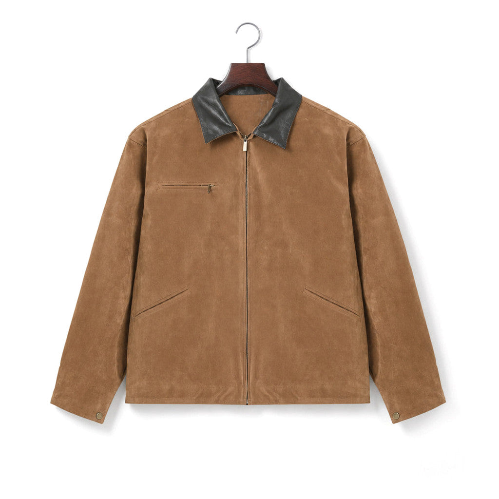 Man wearing brown moleskin zip coat over a knit with dark denim