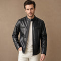 Man wearing a black leather cafe racer jacket with waist tabs fastened