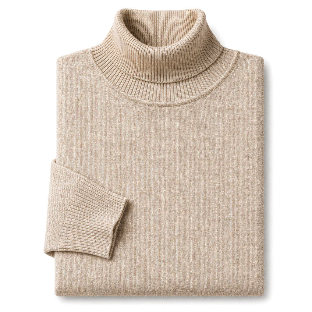 Man wearing khaki turtleneck sweater under an open overcoat