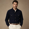 Man wearing deep navy corduroy western shirt open over a tee