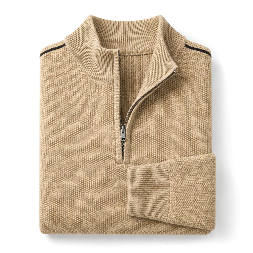 Man wearing light khaki quarter zip waffle jumper with dark trousers