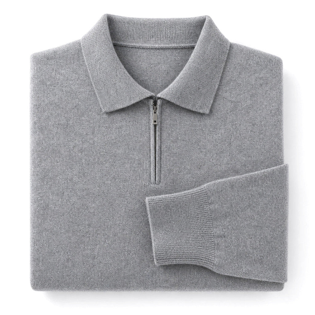 Man wearing gray quarter zip knit polo with dark trousers