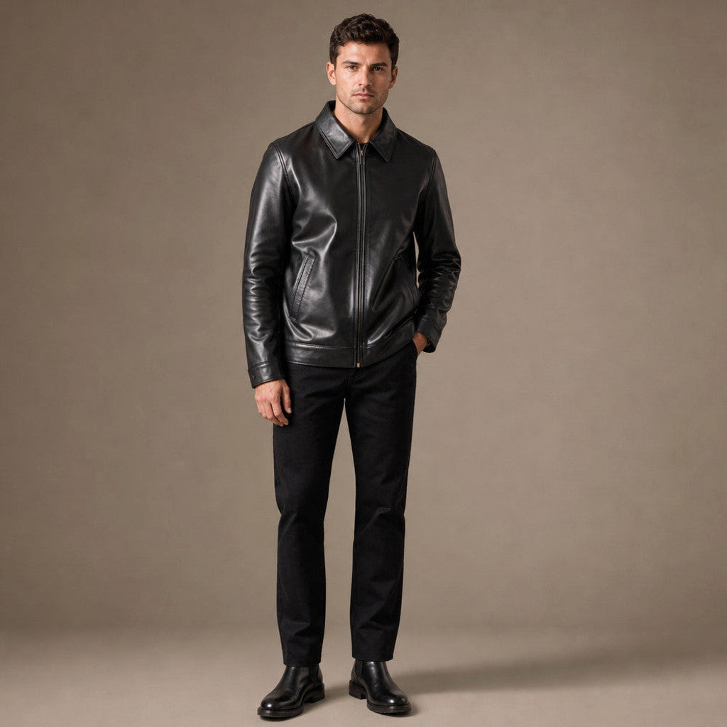 Man wearing black leather Harrington jacket over a knit with dark denim