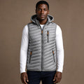 Man wearing silver sleeveless puffer vest over a dark knit