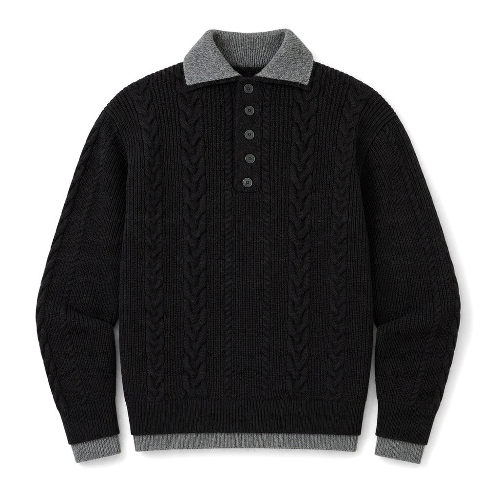 Man wearing black cable knit jumper with faux layered collar and dark denim