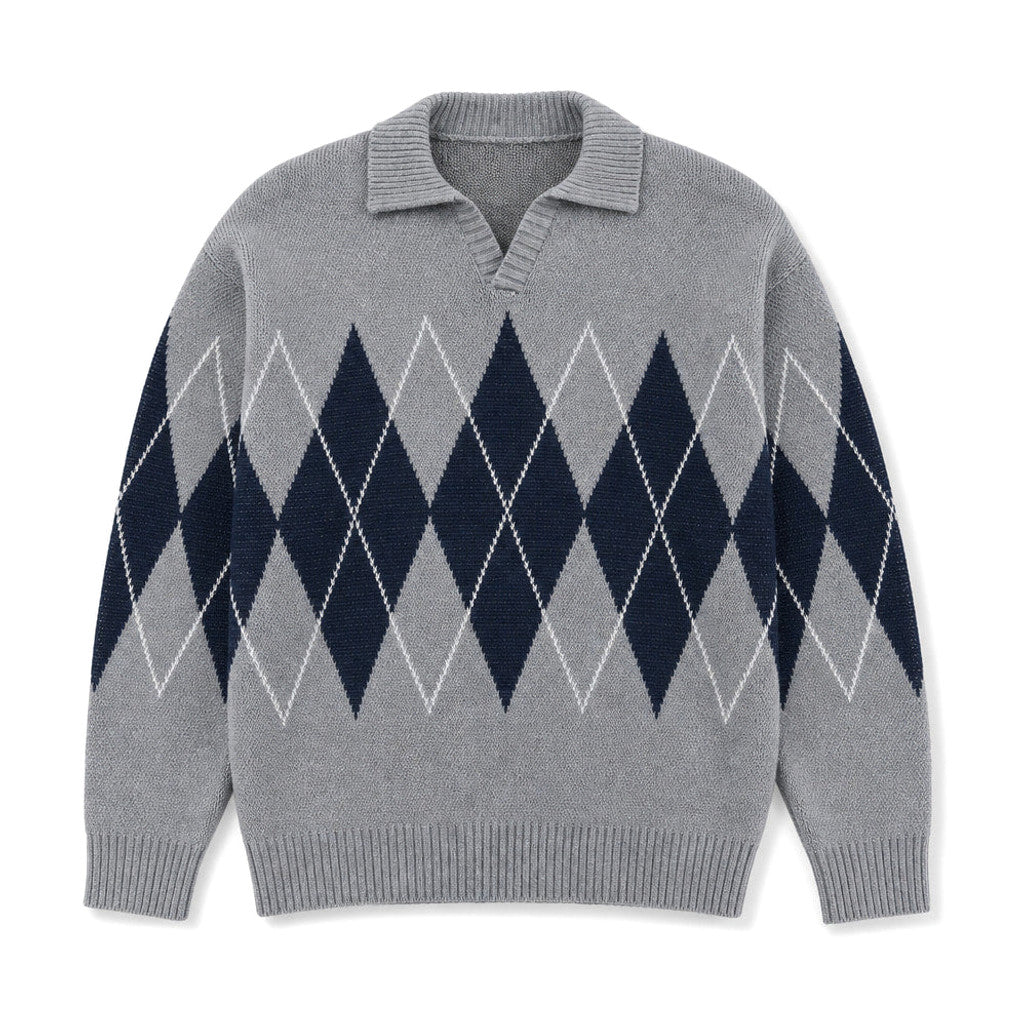 Man wearing grey argyle jumper over a shirt with dark denim