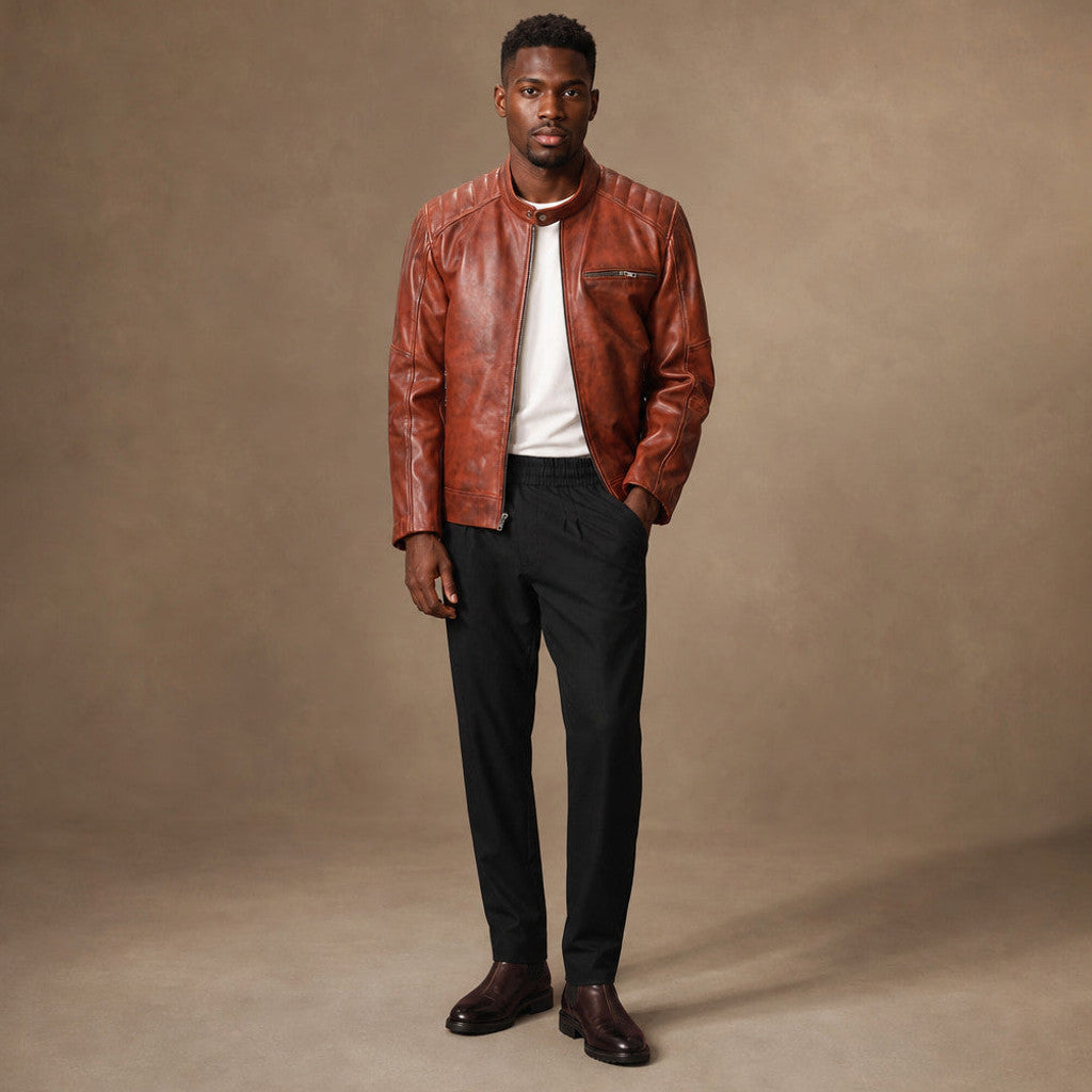 Man wearing cognac brown leather cafe racer jacket over a plain tee with dark denim