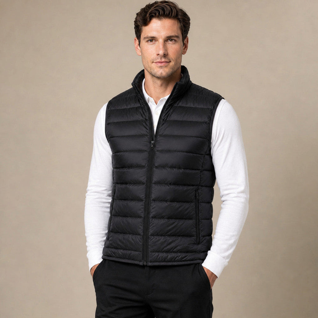 Man wearing black insulated puffer vest over a crewneck