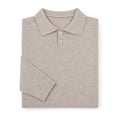 Man wearing oat knit polo with grey flannel trousers