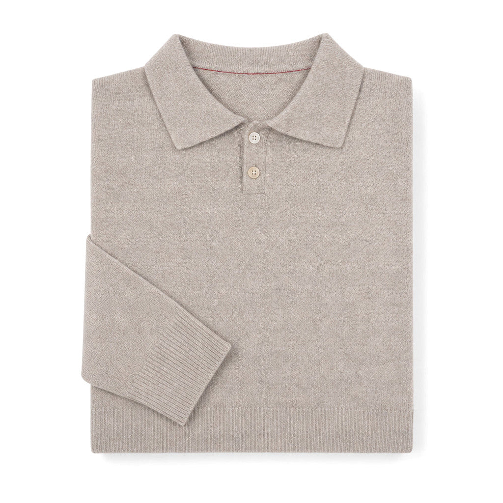 Man wearing oat knit polo with grey flannel trousers