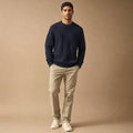 Man wearing a textured knit sweater with matching straight-leg trousers