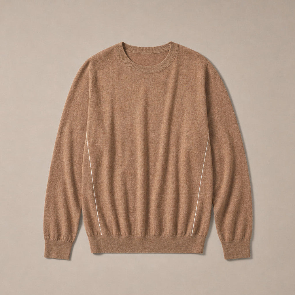 Man wearing camel crewneck jumper over a collared shirt with grey trousers