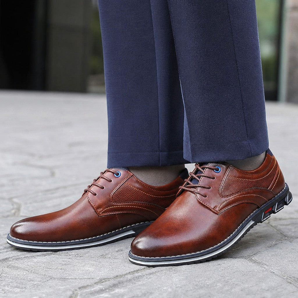 Man wearing brown brogue oxford shoes with grey tailored trousers