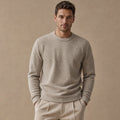 Oat wool birdseye crewneck sweater laid flat showing ribbed collar and cuffs