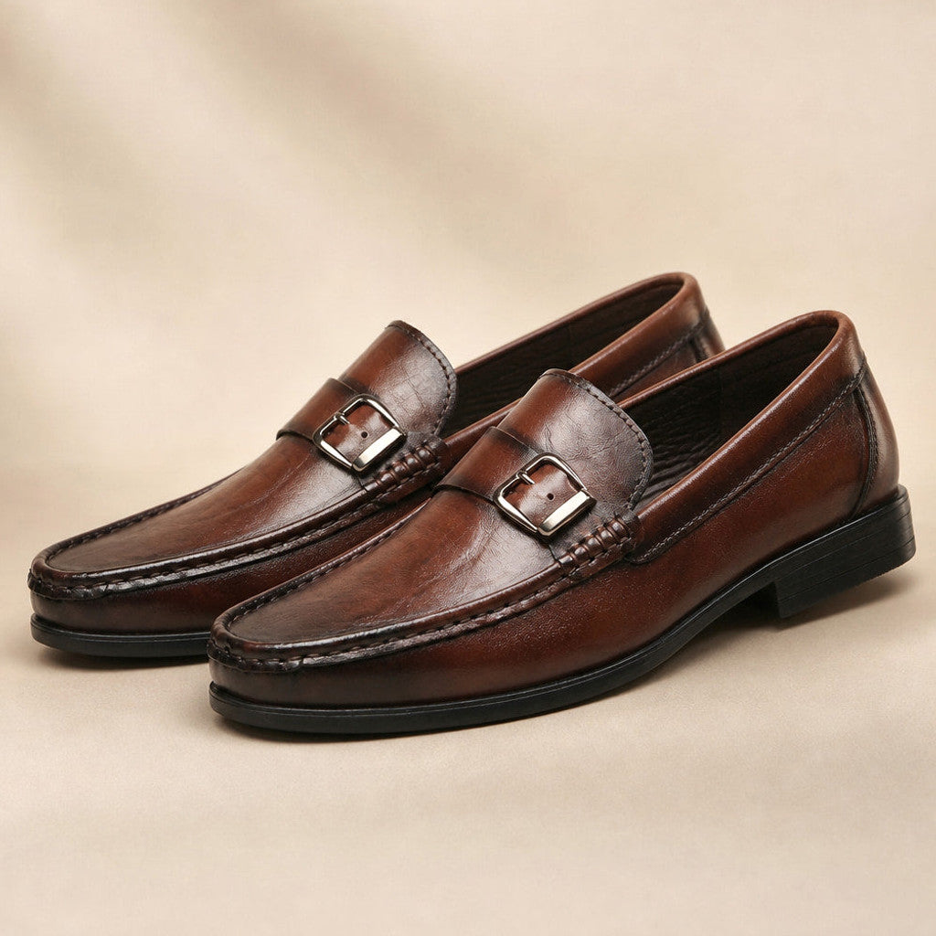 Brown burnished leather loafer with metal bit buckle at the vamp