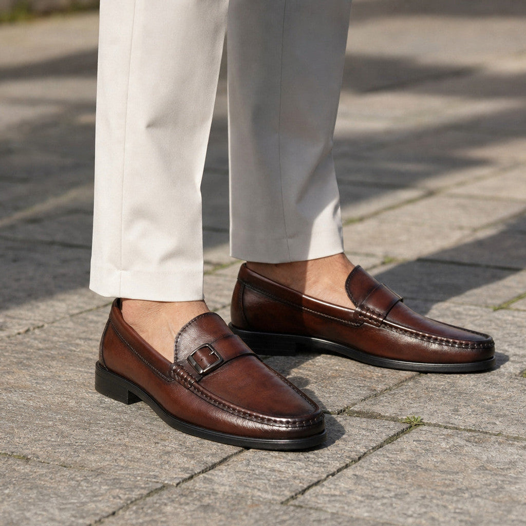 Man wearing brown bit buckle loafers with tailored trousers