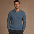 Man wearing glacier blue ribbed knit polo with dark trousers