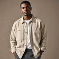 Man wearing a sandstone overshirt open over a plain tee