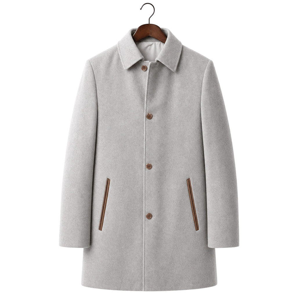 Man wearing grey single-breasted wool car coat over knitwear on a city street