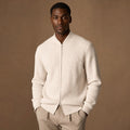 Man wearing ivory ribbed full-zip jacket with straight jeans