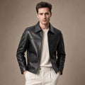 Man wearing a black sheepskin biker jacket over a crew tee with dark denim