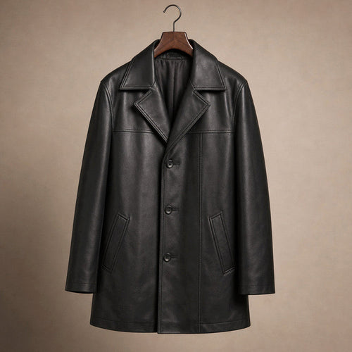 Man wearing a black leather coat buttoned over a dark suit on a city street
