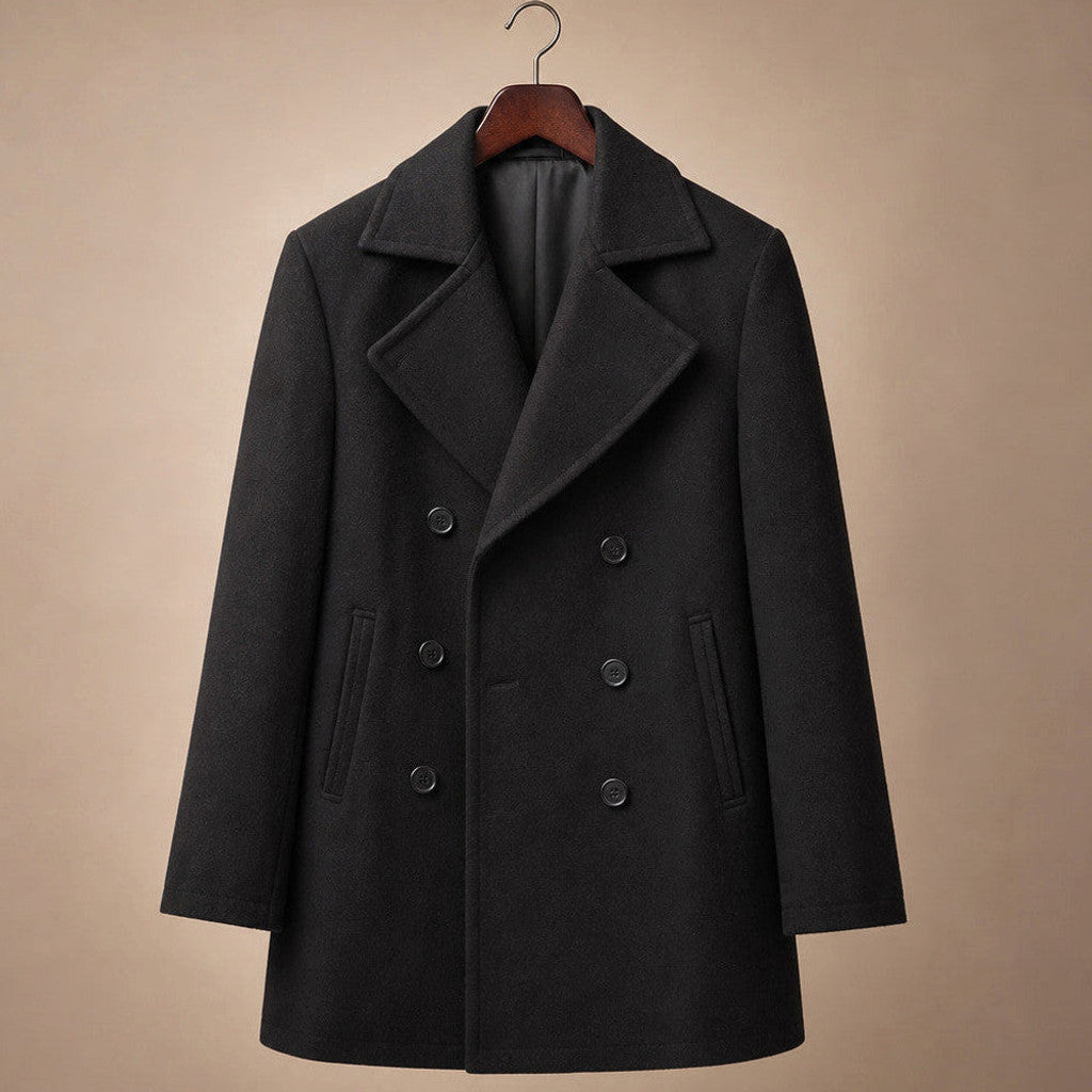 Man wearing black wool pea coat over tailoring on a winter street