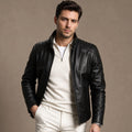 Man wearing a black sheepskin biker jacket with dark denim and boots
