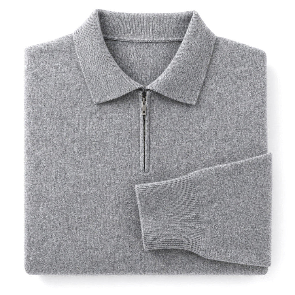 Man wearing gray quarter zip knit polo with dark trousers