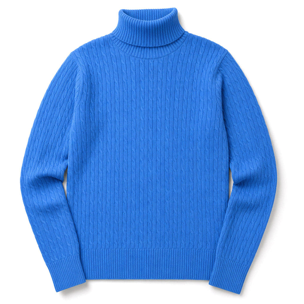 Man wearing a blue cable knit turtleneck sweater with dark trousers
