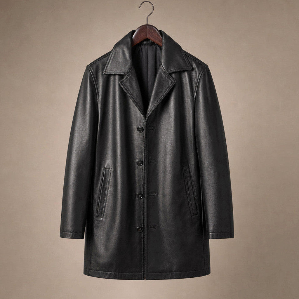 Man wearing black leather pea coat over a jumper on a city street