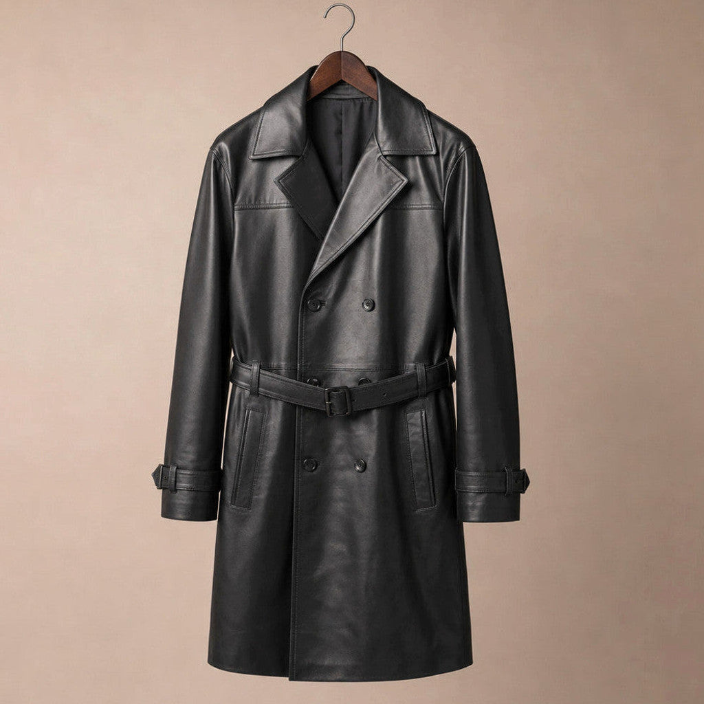 Man wearing a black leather trench coat over tailoring, belt tied