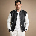 Man wearing a black varsity jacket with leather sleeves over a crewneck