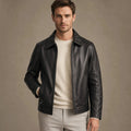 Man wearing a black sheepskin biker jacket over a knit with dark denim