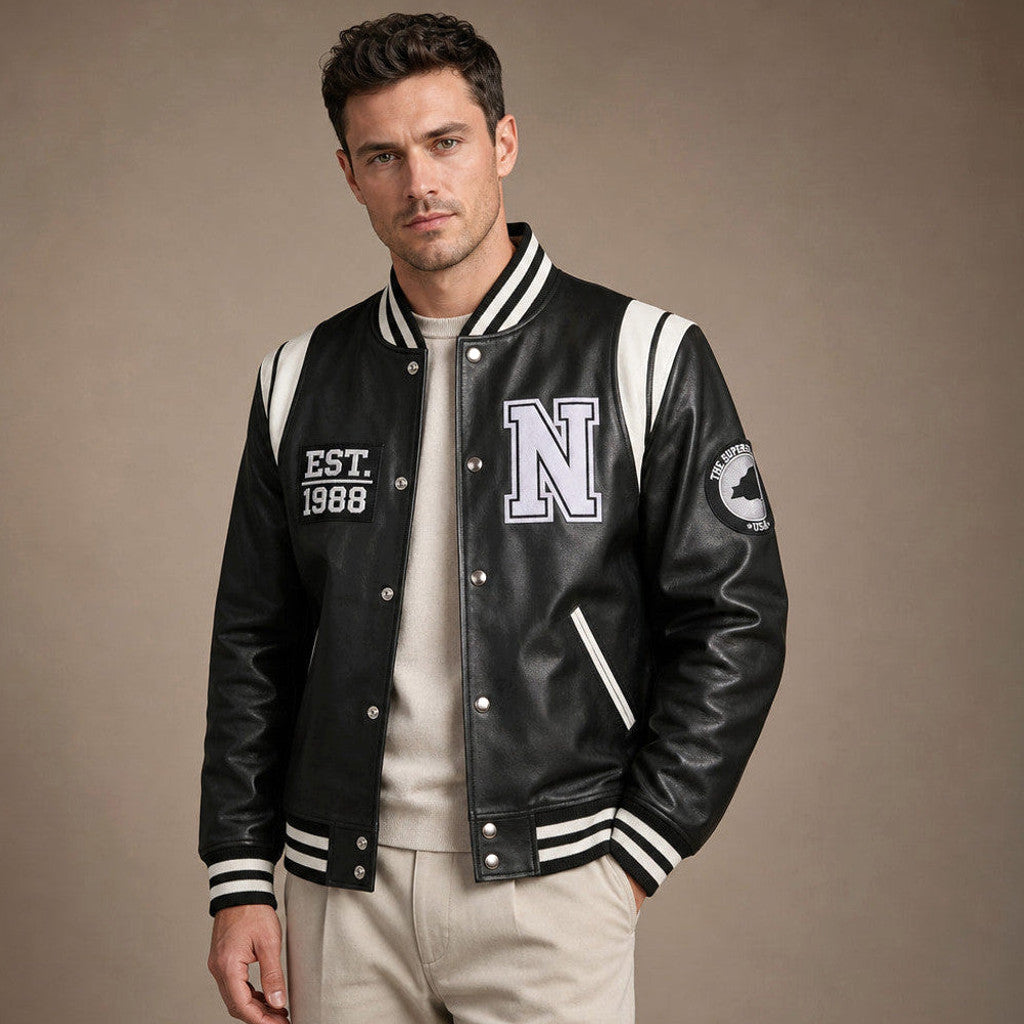 Two-tone black and white sheepskin varsity jacket with ribbed knit collar and cuffs