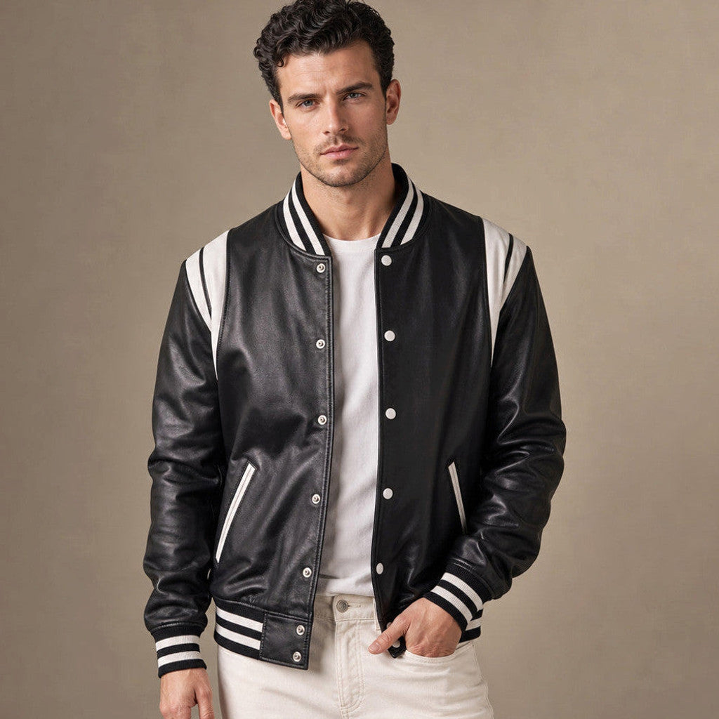 Man wearing a black sheepskin varsity jacket over a sweatshirt with dark denim