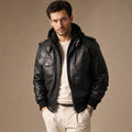 Man wearing a black sheepskin bomber jacket with the hood snapped on