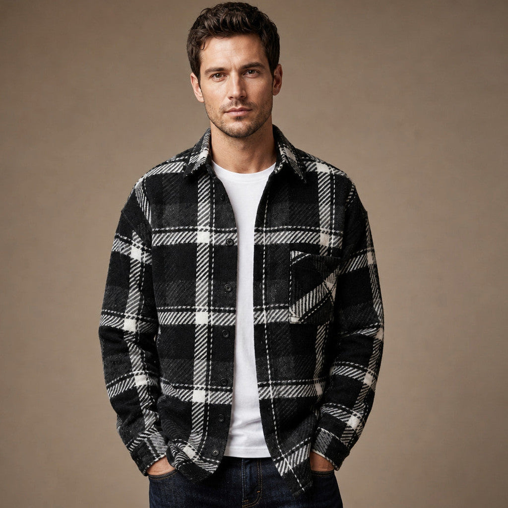 Man wearing black checked sleeveless flannel overshirt over a tee