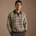 Man wearing brown patterned knit long sleeve polo with wool trousers